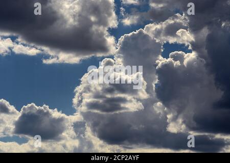 Moisture-filled cumulus clouds float in the sky over the American Southwest. Stock Photo