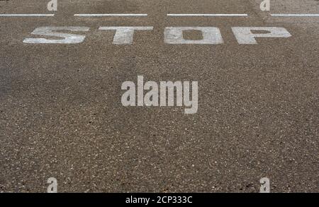 detail of stop sign painted on the asphalt Stock Photo