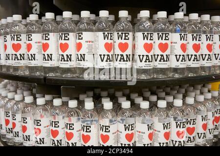 Plastic bottles of Canadian spring water lined up on a supermarket shelf in Vanvouver, British Columbia, Canada Stock Photo