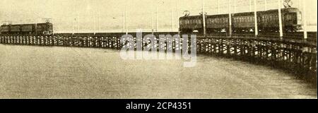 . The Street railway journal . Splltc.l (0 piles ivithUbosit spikes FIG. 11.—TROLLEY POLE CONSTRUCTION ON EMERYVILLEWHARF the rails will be 7 ft. 9 ins. above high water, and 15 ft. 9 ins.above low water. It has a uniform width of 30 ft. throughout,except at the outer end, where it broadens out for the terminaltracks and ferry depot. From the middle of the boat slip tothe west end of the subway under the Southern Pacific tracksat the waters edge, the pier has a length of 16,240 ft., while. FIG. 10.—VIEW OF PIER LOOKING TOWARD LAND, SHOWING TVV O REGULAR 4-CAR TRAINS pass, is located a governme Stock Photo