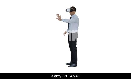 Businessman in virtual reality headset walking in virtual world on white background. Stock Photo