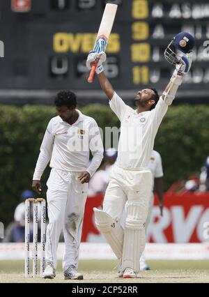 India's Ajinkya Rahane (R) celebrates his century next to Sri Lanka's bowler Tharindu Kaushal during the fourth day of their second test cricket match in Colombo August 23, 2015. REUTERS/Dinuka Liyanawatte