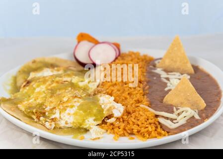 Hueveos Ranchers eggs rice and beans served on a hot plate for some delicious Mexican food. Stock Photo