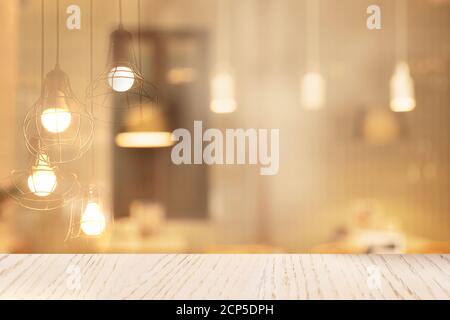top of wood table with white soft lamp light soft cafe interior background Stock Photo