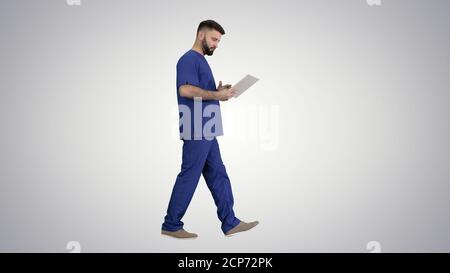 Confident concentrated focused surgeon using digital tablet on g Stock Photo