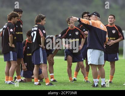 Chile S Cobreloa Coach Nelson Acosta R Picks Up A Cone Near Player Rodrigo Melendez Rear During A Training Session At The Cantera In Mexico City April 23 2003 Mexico S Pumas Will Play