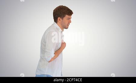 Exhausted young man suffering from heat while walking on gradien Stock Photo