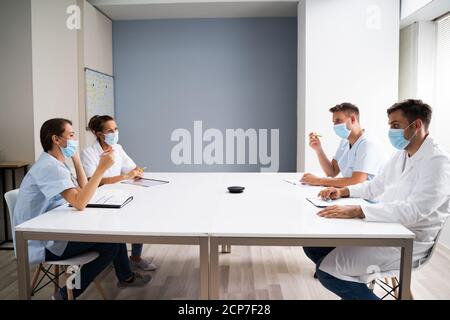Medical Doctor Students At Desk Learning With Face Masks Stock Photo