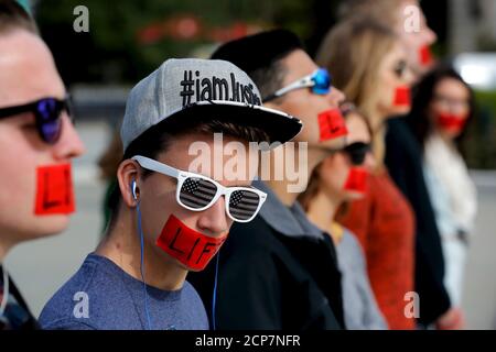 Members of the anti-abortion protest group Bound 4 Life wear red tape over their mouths reading 'Life' as they demonstrate at the U.S. Supreme Court building on the first day of the court's new term in Washington, October 5, 2015. The Supreme Court has not ruled on abortion since 2007 but that could change this term. This fall, the justices are due to decide whether to hear a challenge to a Republican-backed Texas law restricting abortion access that abortion providers contend is aimed more at shutting clinics than protecting women's health. REUTERS/Jonathan Ernst