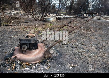 TALENT, ORE - SEPTEMBER 18, 2020: A general view of a burned out lawnmower amid the aftermath of the Almeda Fire. The town of Talent, Oregon, showing the burned out homes, cars and rubble left behind. In Talent, about 20 miles north of the California border, homes were charred beyond recognition. Across the western US, at least 87 wildfires are burning, according to the National Interagency Fire Center. They've torched more than 4.7 million acres -- more than six times the area of Rhode Island. Credit: Chris Tuite/imageSPACE