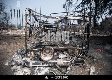 TALENT, ORE - SEPTEMBER 18, 2020: A general view of a burned out vehicle amid the aftermath of the Almeda Fire. The town of Talent, Oregon, showing the burned out homes, cars and rubble left behind. In Talent, about 20 miles north of the California border, homes were charred beyond recognition. Across the western US, at least 87 wildfires are burning, according to the National Interagency Fire Center. They've torched more than 4.7 million acres -- more than six times the area of Rhode Island. Credit: Chris Tuite/imageSPACE