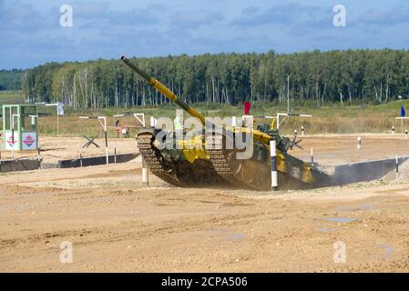 ALABINO, RUSSIA - AUGUST 25, 2020: T-72B3 tank of Kazakhstan team overcomes obstacle 'Moat'. Fragment of international military competition Stock Photo