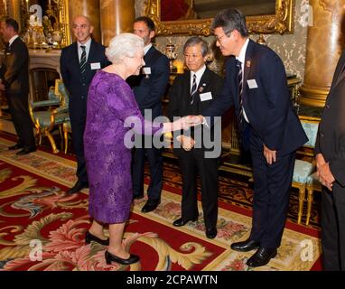 Britain's Queen Elizabeth and the Duke of Edinburgh (L) meet with South Africa's Bryan Habana (3rd R), Australia's Henry Speight and South Africa's Victor Matfield (R) at a Rugby World Cup reception at Buckingham Palace, London October 12, 2015. REUTERS/Dominic Lipinski/PoolQueen Elizabeth II meets Chairman of Japan Rugby Football Union Noriyuki Sakamoto (centre) and Special Director of Japan RFU Naoki Maeda at a Rugby World Cup reception at Buckingham Palace, London. PRESS ASSOCIATION Photo. Picture date: Monday October 12, 2015. See PA story ROYAL Rugby. Photo credit should read: Dominic Lip