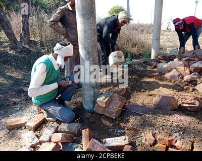 DISTRICT KATNI, INDIA - DECEMBER 13, 2019: Group of indian village labours working together at construction site. Stock Photo