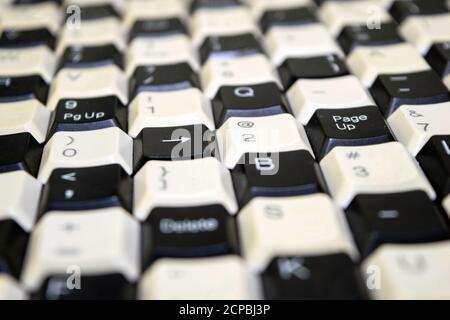 a set of keys from old computer keyboards laid out on the table in a staggered manner Stock Photo