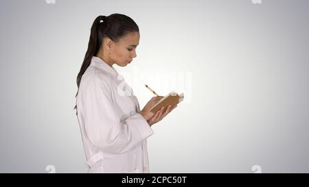Successful medical doctors making notes while walking on gradien Stock Photo
