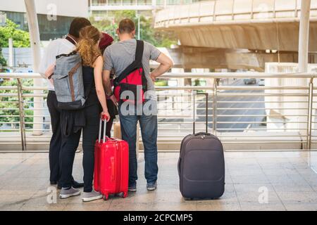 Lost group traveller asking for help while looking at the map. Travel problem and lost concept. Stock Photo