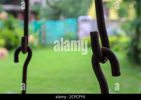 Rusted metallic chains holding together. Swing metal chain Links closeup. Stock Photo