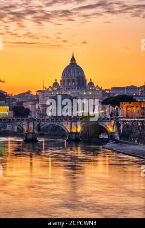 Sunset over the St. Peters Basilica and the river Tiber in Rome Stock Photo