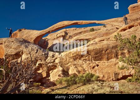 Hikers at Landscape Arch, Arches National Park, Utah, USA Stock Photo