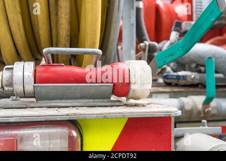 Close up of a fire hose reel, mounted at the rear of a New South Wales Rural Fire Service truck. Water is fed by an onboard generator and water tank Stock Photo