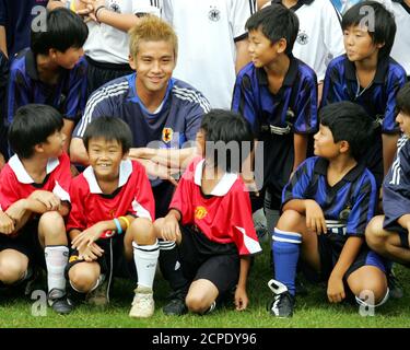 Japanese Soccer Player Junichi Inamoto L Holds His Team Strip With Arsenal Manager Arsene Wenger After Signing For Arsenal Football Club July 23 01 Inamoto 21 Signed With Arsenal As A Midfielder