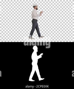 Engineer in hardhat walking and explaining something, Alpha Chan Stock Photo