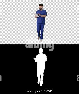 Confident concentrated focused surgeon using digital tablet, Alp Stock Photo