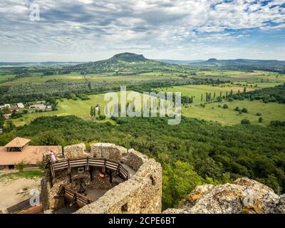 SZIGLIGET, HUNGARY - 08/26/2020: Medieval castle ruins of Szigliget with the Csobanc mountain in the background at Balaton lake in Hungary. Stock Photo