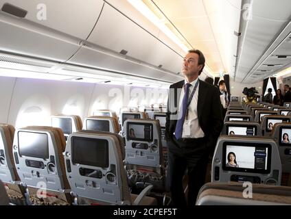Fabrice Bregier, President and CEO of Airbus, looks around in the economy class cabin during a tour of the first of 67 new Airbus A350-900 planes delivered to Singapore Airlines at Singapore's Changi Airport March 3, 2016. REUTERS/Edgar Su