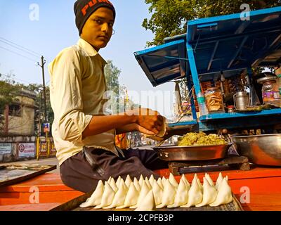 DISTRICT KATNI, INDIA - JANUARY 18, 2020: An indian boy making samosa on street food corner. Stock Photo