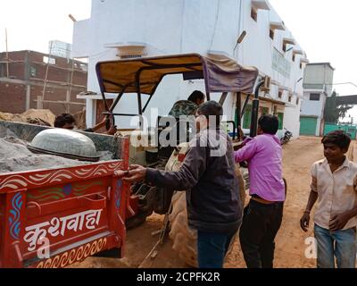 DISTRICT KATNI, INDIA - JANUARY 18, 2020: Indian local people pushing tractor for charging up on road. Stock Photo