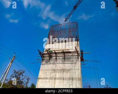 DISTRICT KATNI, INDIA - JANUARY 18, 2020: Cemented pillar construction for over bridge building at blue sky background. Stock Photo