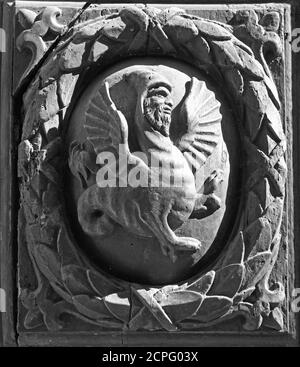 Fantasy character man-dragon carved in wood, black & white Stock Photo