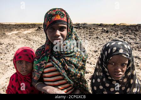 Afar nomads, children, working in the salt desert, Danakil depression, Afar region, Ethiopia, Africa Stock Photo