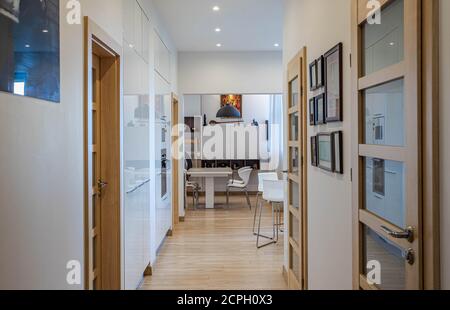 Gallery Detail: The Hallway Of A House With Cabinets And Wooden Shelves