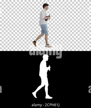 Young man playing ukulele while walking, Alpha Channel with Silh Stock Photo