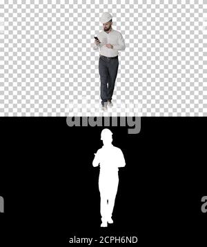 Engineer walking and using smartphone, Alpha Channel with Silhou Stock Photo