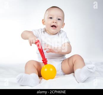 Photo of a eleven-month-old baby with rattle Stock Photo