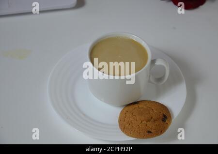office table with notebook, computer keyboard, mouse, cup of coffee, red rouse. copy space Stock Photo