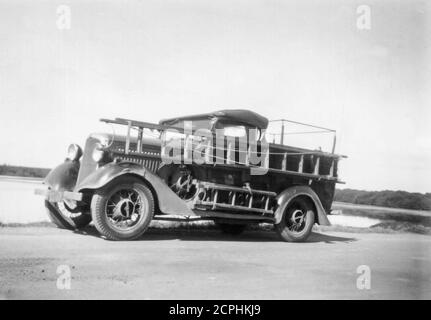 A Sydney County Council, English made1935 Morris 8 vehicle with a most likely Australian made utility chassis and soft top cabin cover. This was a Council District Operator's vehicle that carried wooden ladders on the passenger side which wasn't a problem because it was used by only one driver/worker at a time. The location of the shot is unavailable but may be near Rhodes in Sydney where the driver of the vehicle lived at the time. The vehicle had a small search light mounted on the drivers door and was in radio contact with head office. Stock Photo