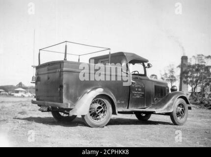 A Sydney County Council, English made1935 Morris 8 vehicle with a most likely Australian made utility chassis and soft top cabin cover. This was a Council District Operator's vehicle that carried wooden ladders on the passenger side which wasn't a problem because it was used by only one driver/worker at a time. The location of the shot is unavailable but may be near Rhodes in Sydney where the driver of the vehicle lived at the time. The vehicle had a small search light mounted on the drivers door and was in radio contact with head office. Stock Photo