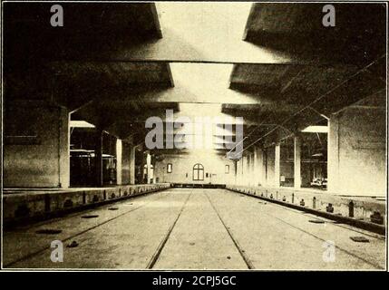 . The Street railway journal . VIEW OF THE ROOF, SHOWING THE GREAT AMOUNT OF SKYLIGHT SURFACETHE LOCATION OF THE SKYLIGHTS AND. VIEW ALONG THE UPPER TRANSFER TABLE RUNWAY, ILLUSTRATING THE HEAVYROOF BEAMS, HOLLOW TILE PARTITIONS AND THE ROOF DRAINS barrows and for the roof work was elevated in automaticdumping buckets. The columns are reinforced with plainround bars, but Johnson corrugated bars are in all the otherconcrete construction. The floors over the basement were designed to carry 20-ton cars and for this reason were rather heavily rein-forced. They are supported on concrete columns 18 Stock Photo