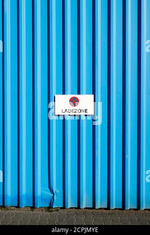 Sign loading zone on a blue wall of a commercial hall in the Osthafen, Frankfurt am Main, Hesse, Germany Stock Photo