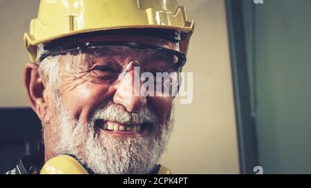 Senior factory worker or engineer close up portrait in factory . Industry and engineering concept .