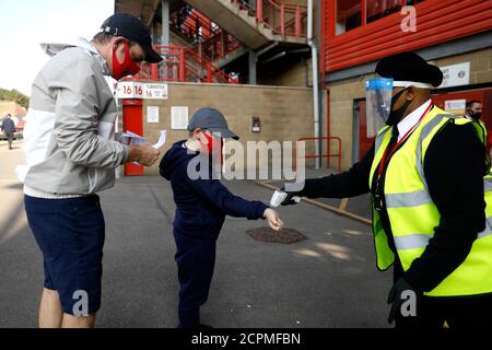 A Charlton Athletic fan has their temperature checked before entering the ground where up to 1000 spectators are expected to attend the Sky Bet League One match at The Valley, London. Stock Photo