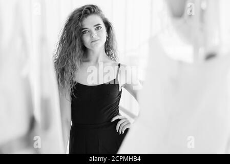 Girl ballerina with curly hair. Black and white photo. BW Stock Photo