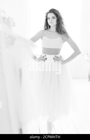 Girl ballerina with curly hair. Black and white photo. BW Stock Photo