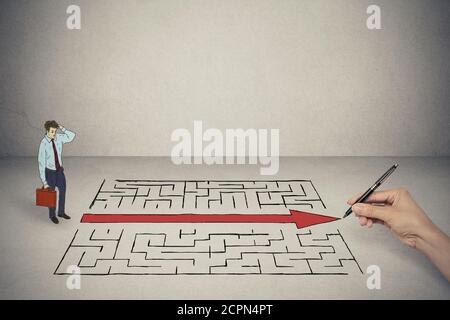 Business man looking at hand drawing solution for maze Stock Photo