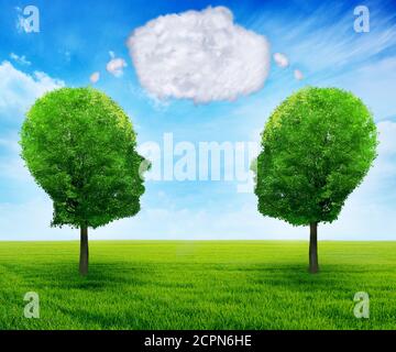 Growing network communication with group of two trees shaped as human head with blank word bubble made of clouds business concept of team growth sendi Stock Photo